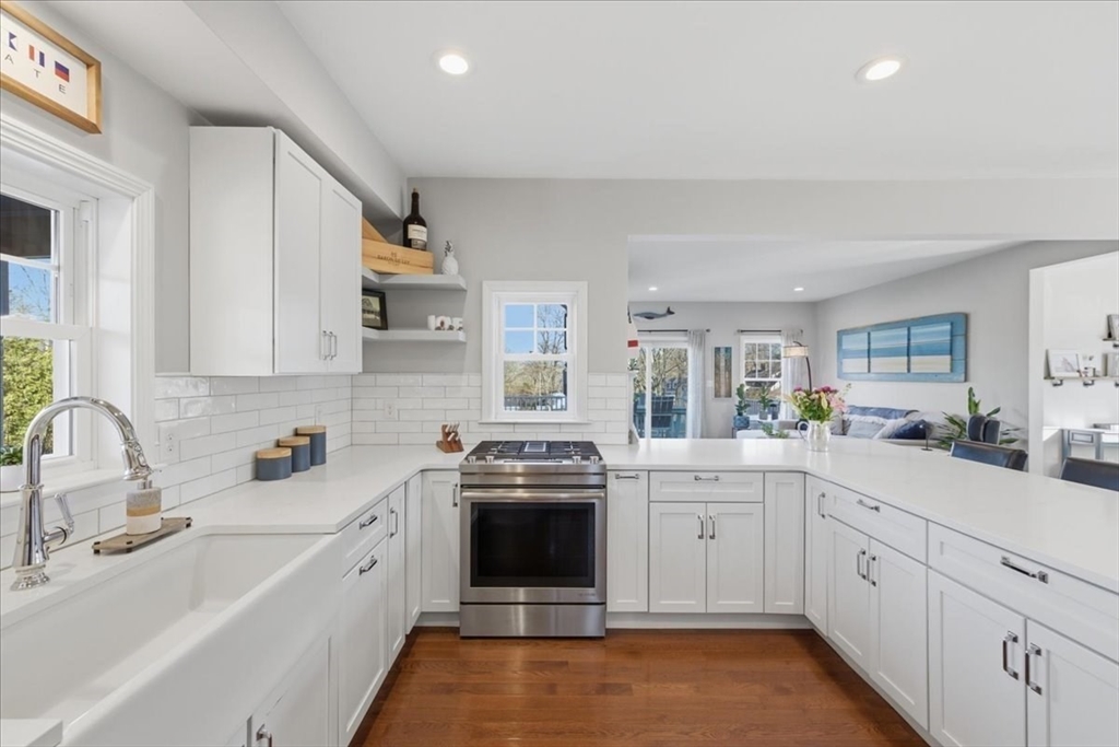 27 Curtis Street Scituate, MA 02066 - Photo 6 of 40 a kitchen with a sink stove and cabinets