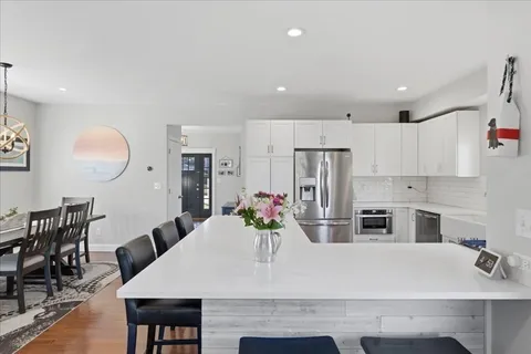 a large kitchen with a table and chairs