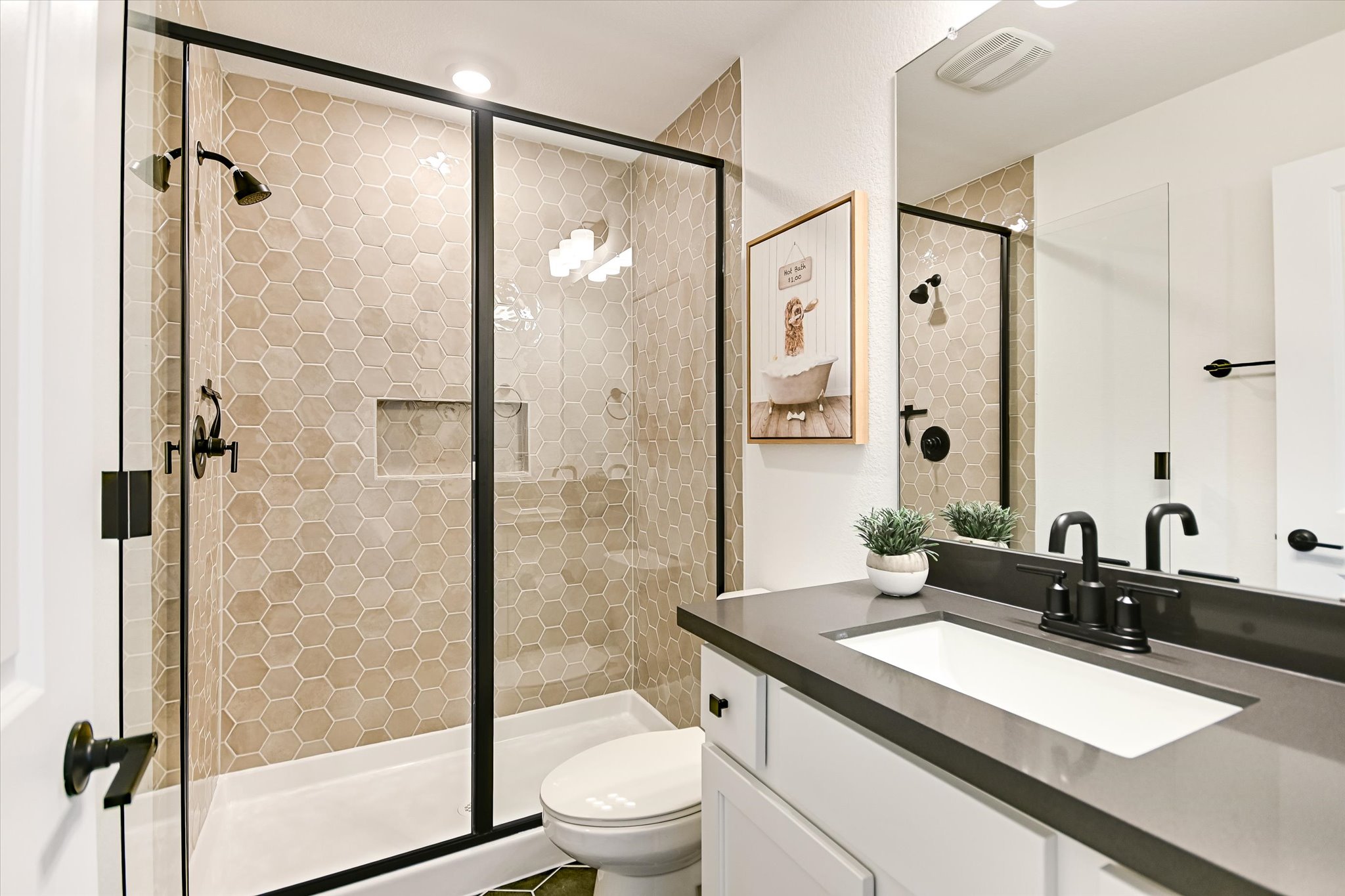 1928 Varese Path Leander, TX 78641 - Photo 13 of 31 a bathroom with a granite countertop sink mirror toilet and shower
