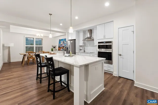 a view of a dining room with furniture wooden floor and chandelier
