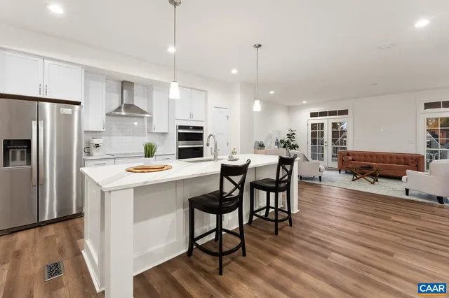 a kitchen with stainless steel appliances a stove a sink and a refrigerator