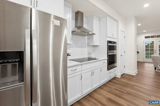 a view with kitchen island a sink and living room view