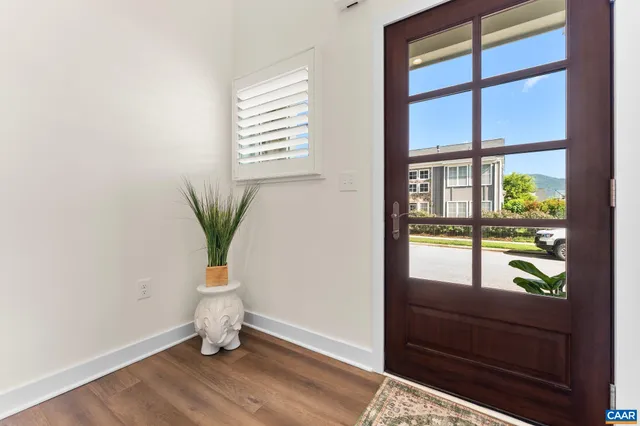 a view of entryway and hall with wooden floor