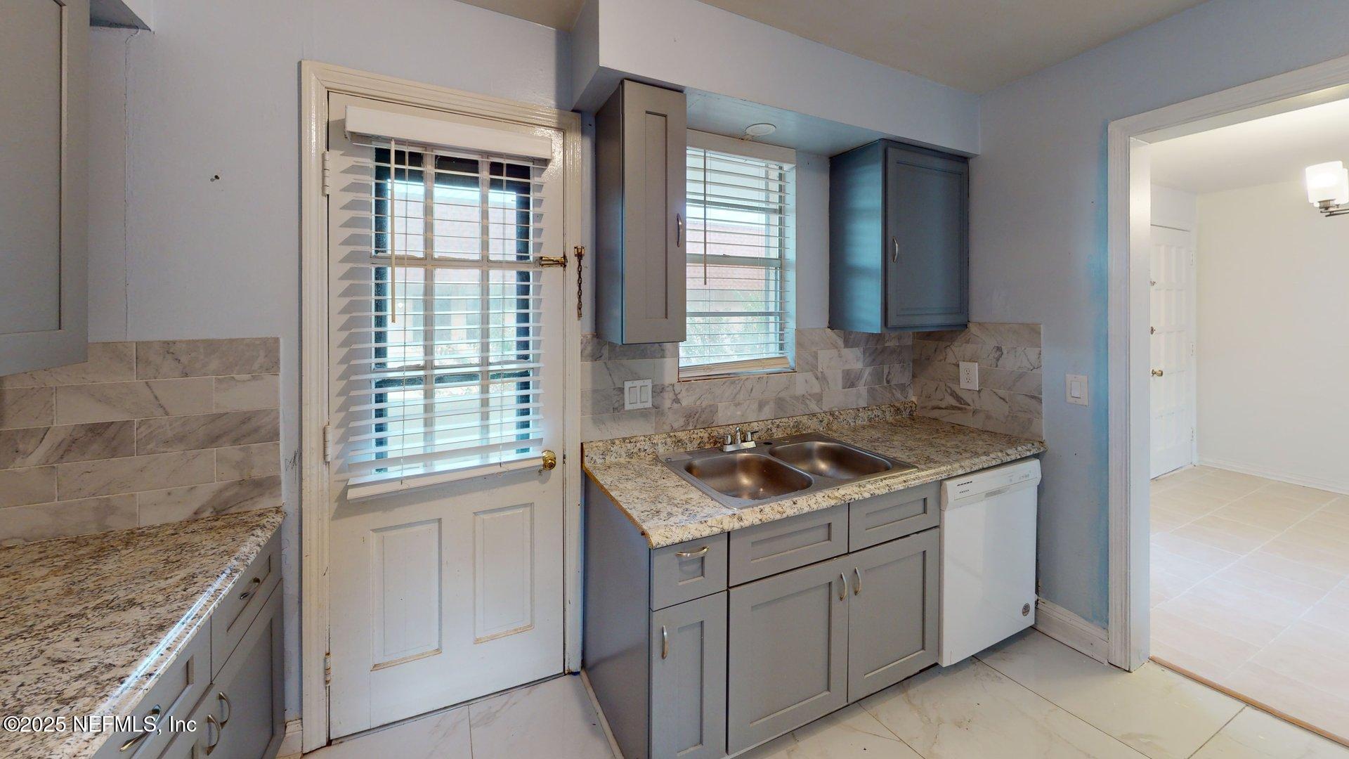 1540 El Prado Road, Unit 4 Jacksonville, FL 32216 - Photo 9 of 24 a kitchen with a sink stove and cabinets