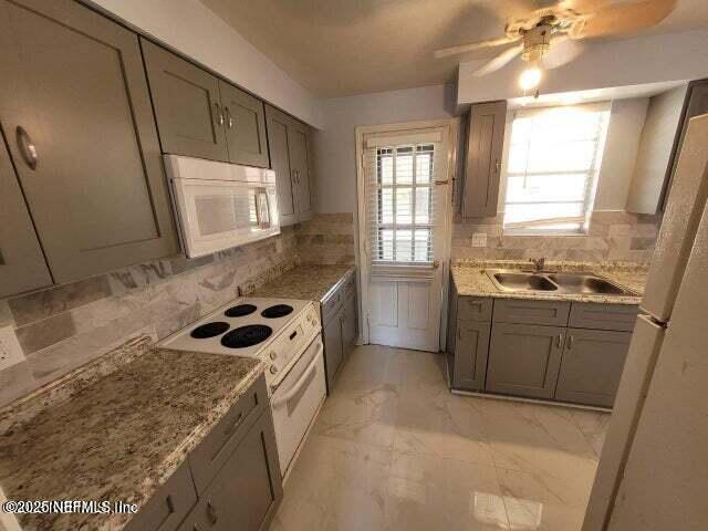 1540 El Prado Road, Unit 4 Jacksonville, FL 32216 - Photo 10 of 24 a kitchen with a sink a stove cabinets and a window