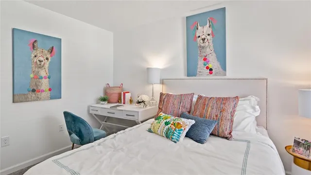 a bedroom with a bed and a painting on the wall