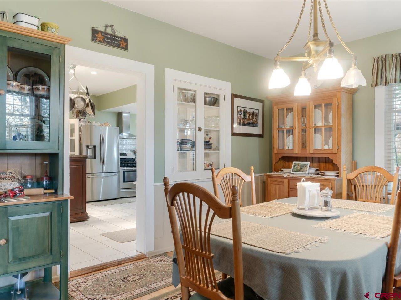 15318 6100th Road Montrose, CO 81403 - Photo 14 of 35 a view of a a dining room with furniture window and wooden floor