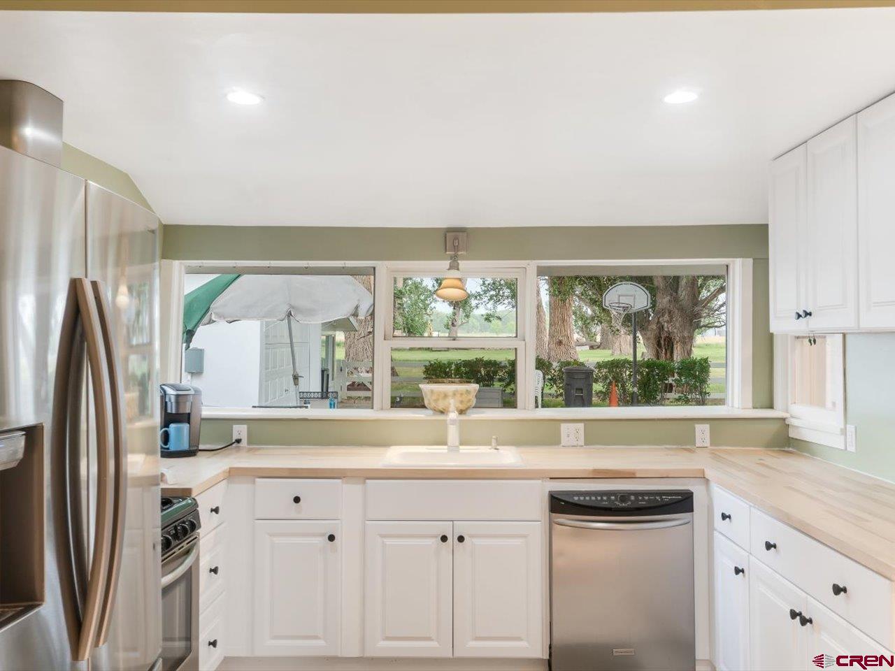 15318 6100th Road Montrose, CO 81403 - Photo 16 of 35 a kitchen with stainless steel appliances a sink and a window