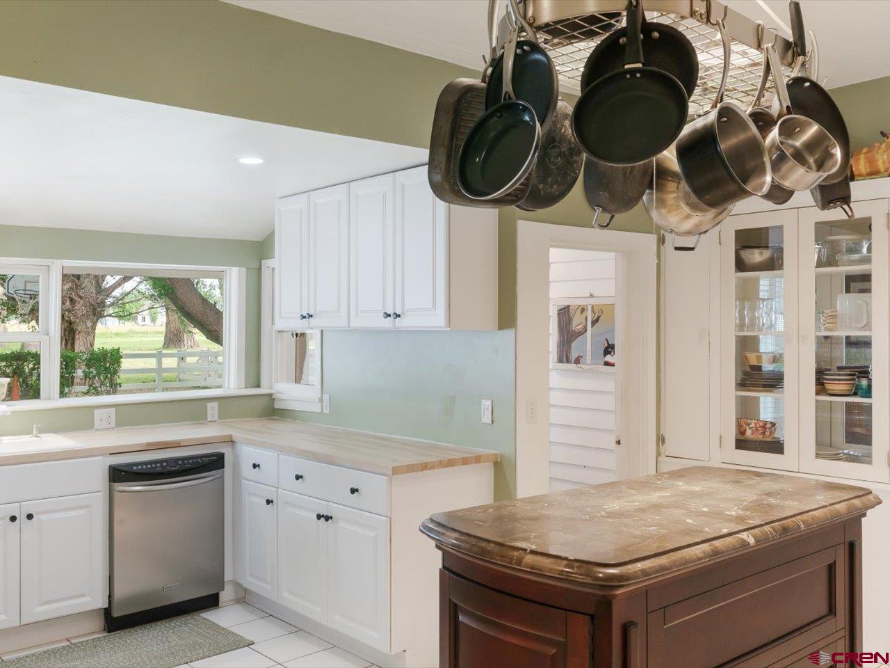 15318 6100th Road Montrose, CO 81403 - Photo 18 of 35 a kitchen with a stove a white cabinet and a granite countertops