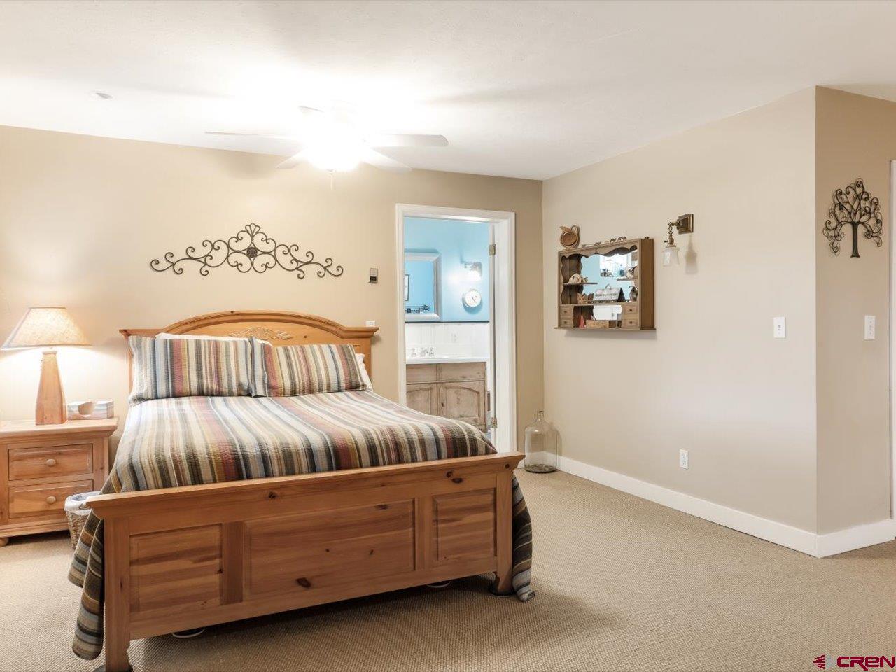 15318 6100th Road Montrose, CO 81403 - Photo 20 of 35 a living room with furniture and a lamp