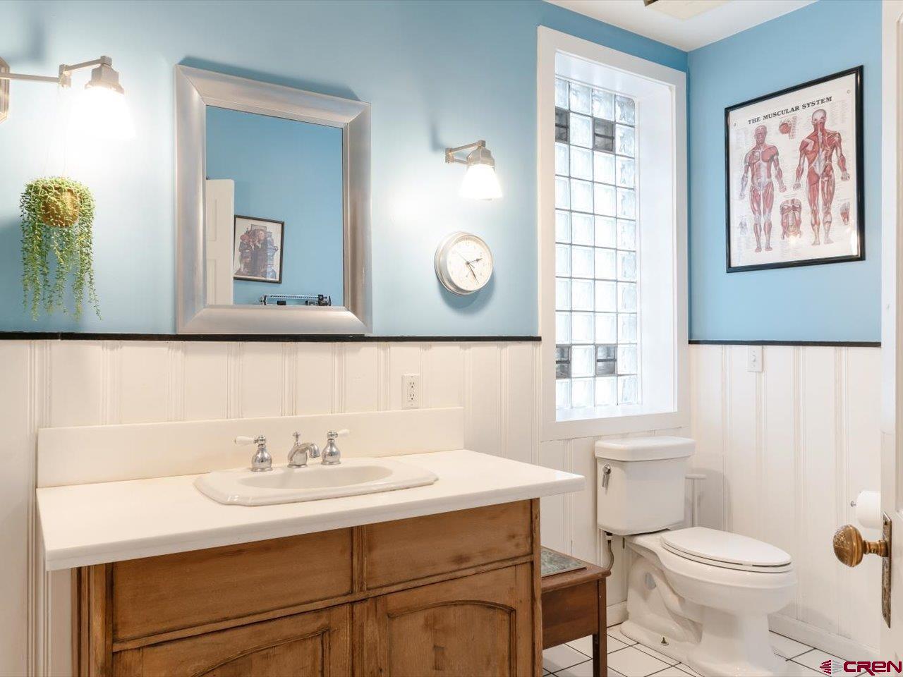 15318 6100th Road Montrose, CO 81403 - Photo 23 of 35 a bathroom with a sink a toilet a mirror and a window