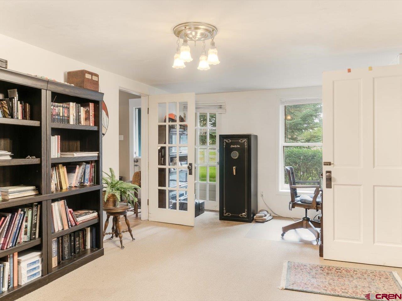 15318 6100th Road Montrose, CO 81403 - Photo 24 of 35 a view of a livingroom with furniture and a book shelf
