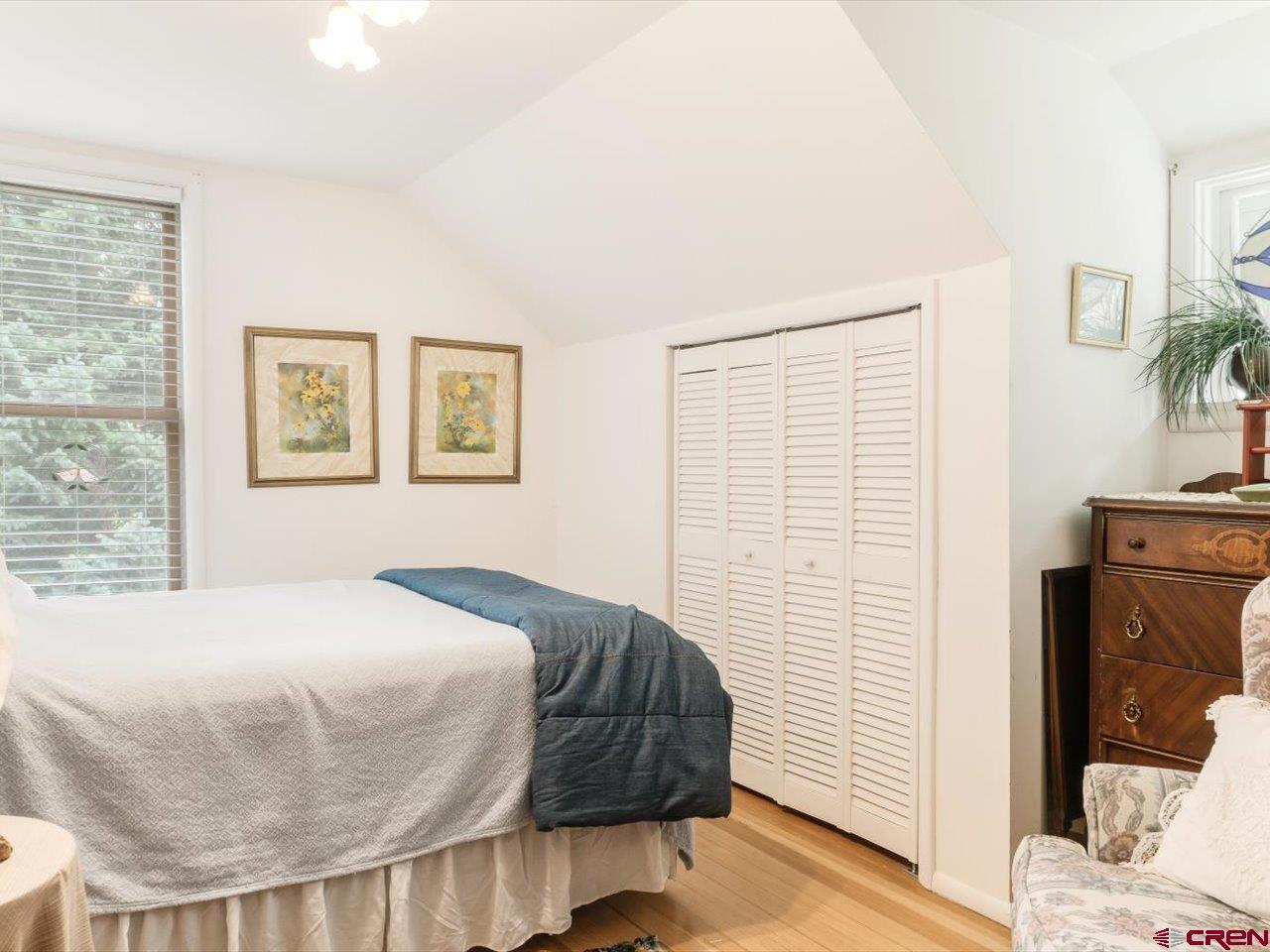 15318 6100th Road Montrose, CO 81403 - Photo 27 of 35 a bedroom with a bed and wooden floor