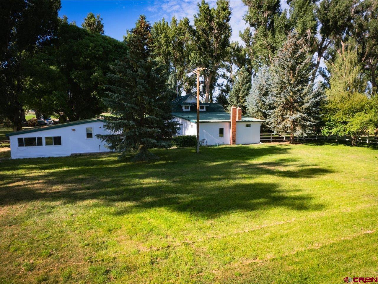 15318 6100th Road Montrose, CO 81403 - Photo 7 of 35 a view of a house with a swimming pool