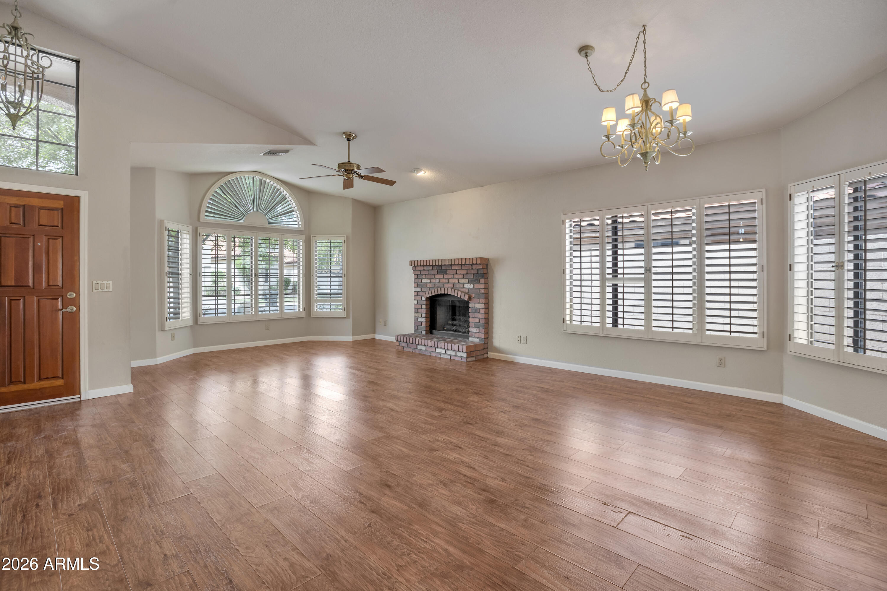 57 East Ranch Road Tempe, AZ 85284 - Photo 11 of 51 a view of an empty room with wooden floor and a window