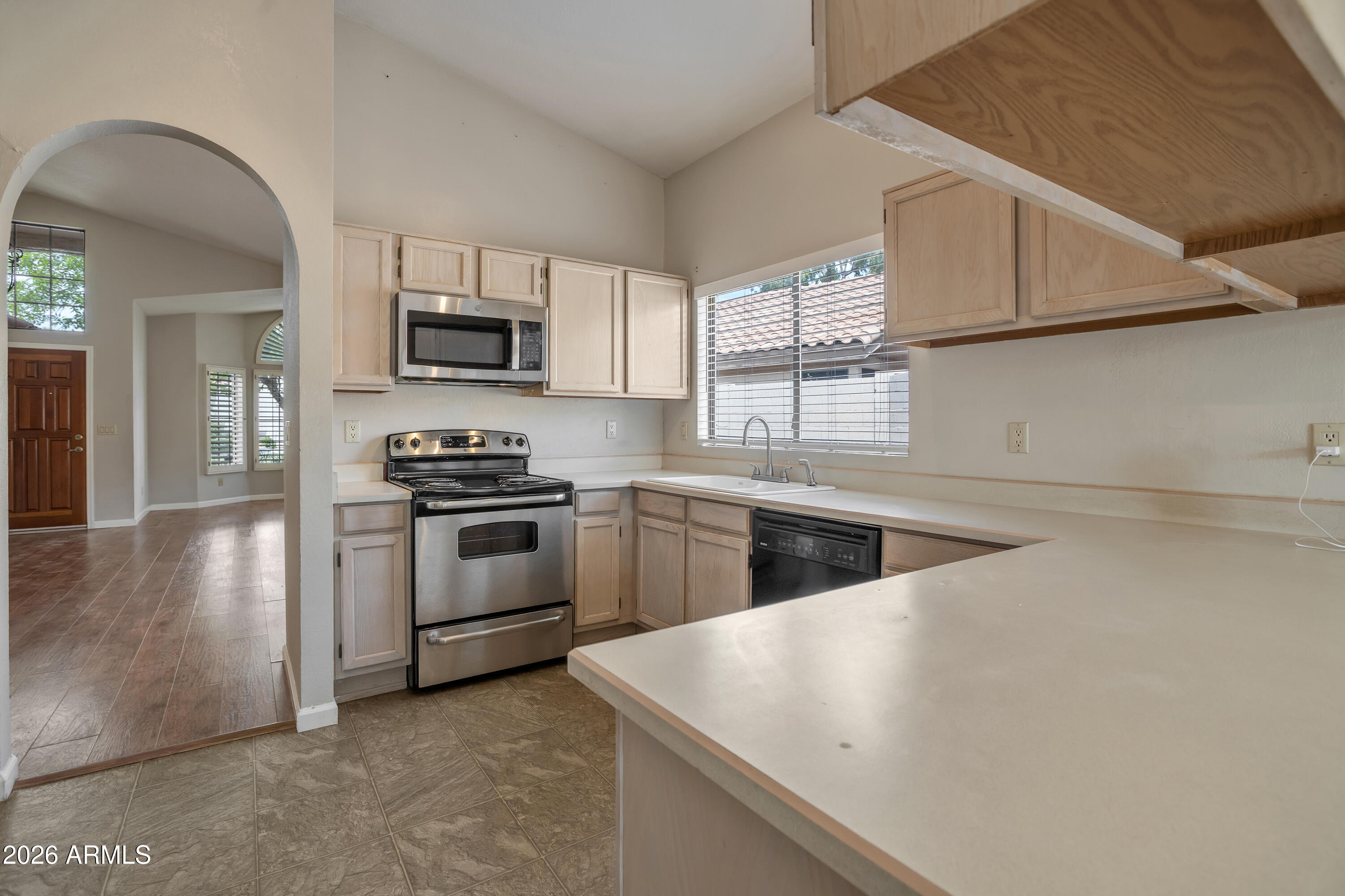 57 East Ranch Road Tempe, AZ 85284 - Photo 14 of 51 a kitchen with white cabinets and stainless steel appliances