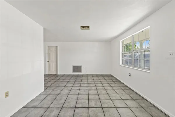 a view of an empty room with windows