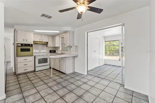 a kitchen with stainless steel appliances a stove refrigerator sink and cabinets