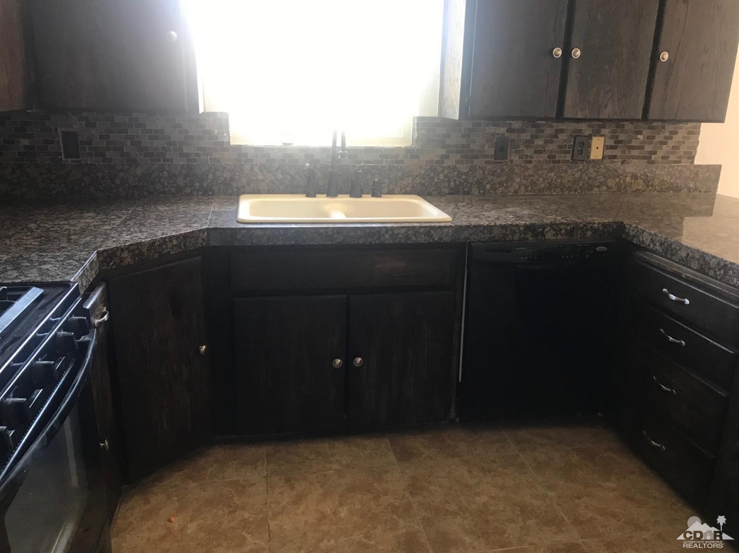 68535 Risueno Road Cathedral City, CA 92234 - Photo 7 of 15 a kitchen with a sink and cabinets