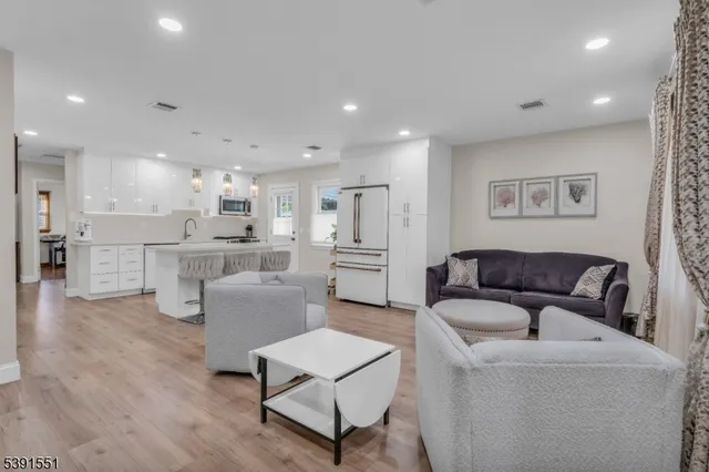 a living room with furniture and kitchen view