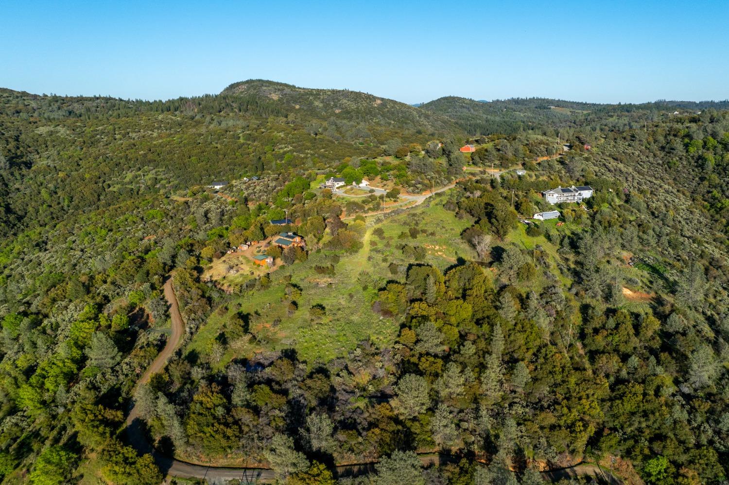 18678 Kentucky Ravine Road Nevada City, CA 95959 - Photo 7 of 11 a view of a lush green field with mountains in the background