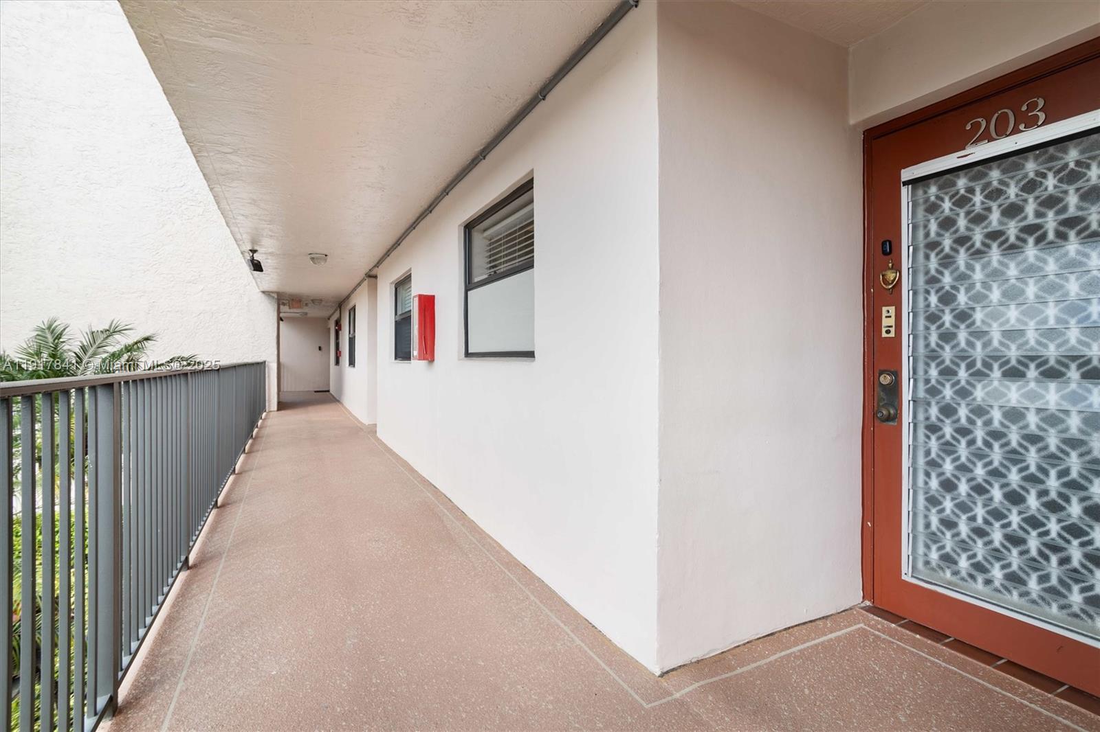 10207 Sunrise Lakes Boulevard, Unit 203 Sunrise, FL 33322 - Photo 22 of 39 a hallway with wooden floor and windows
