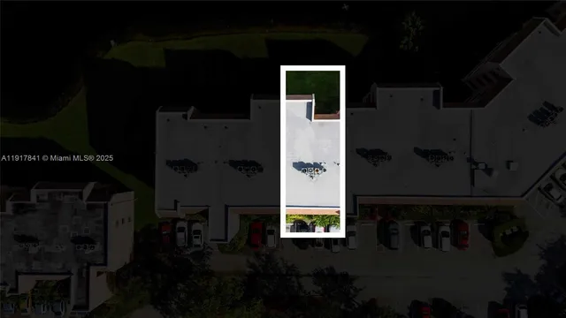 an aerial view of a building with an outdoor space