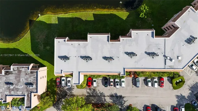 an aerial view of a house with a yard and a fountain
