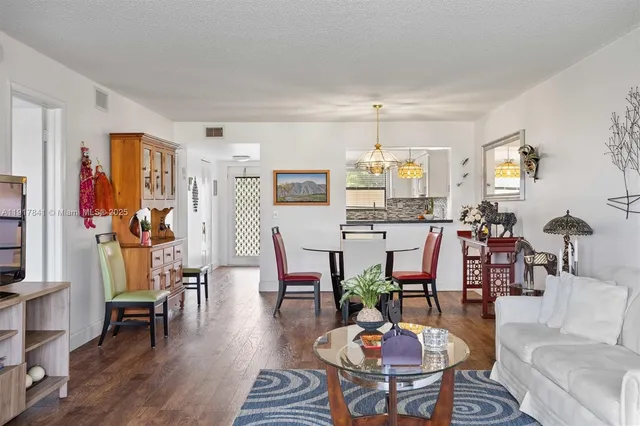 a living room with lots of furniture and wooden floor
