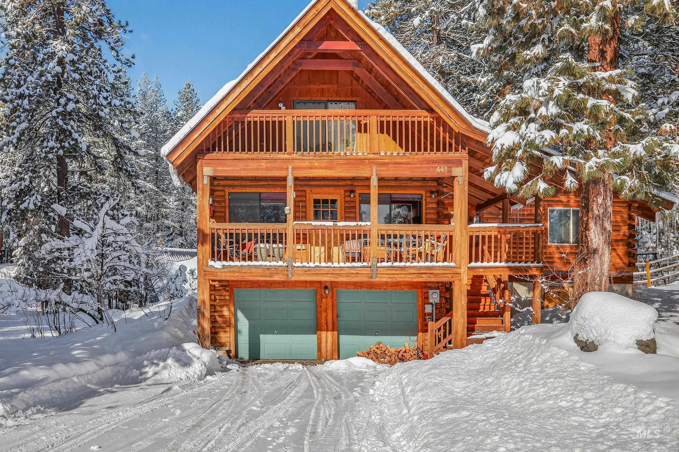 View of front of house featuring a garage and covered porch