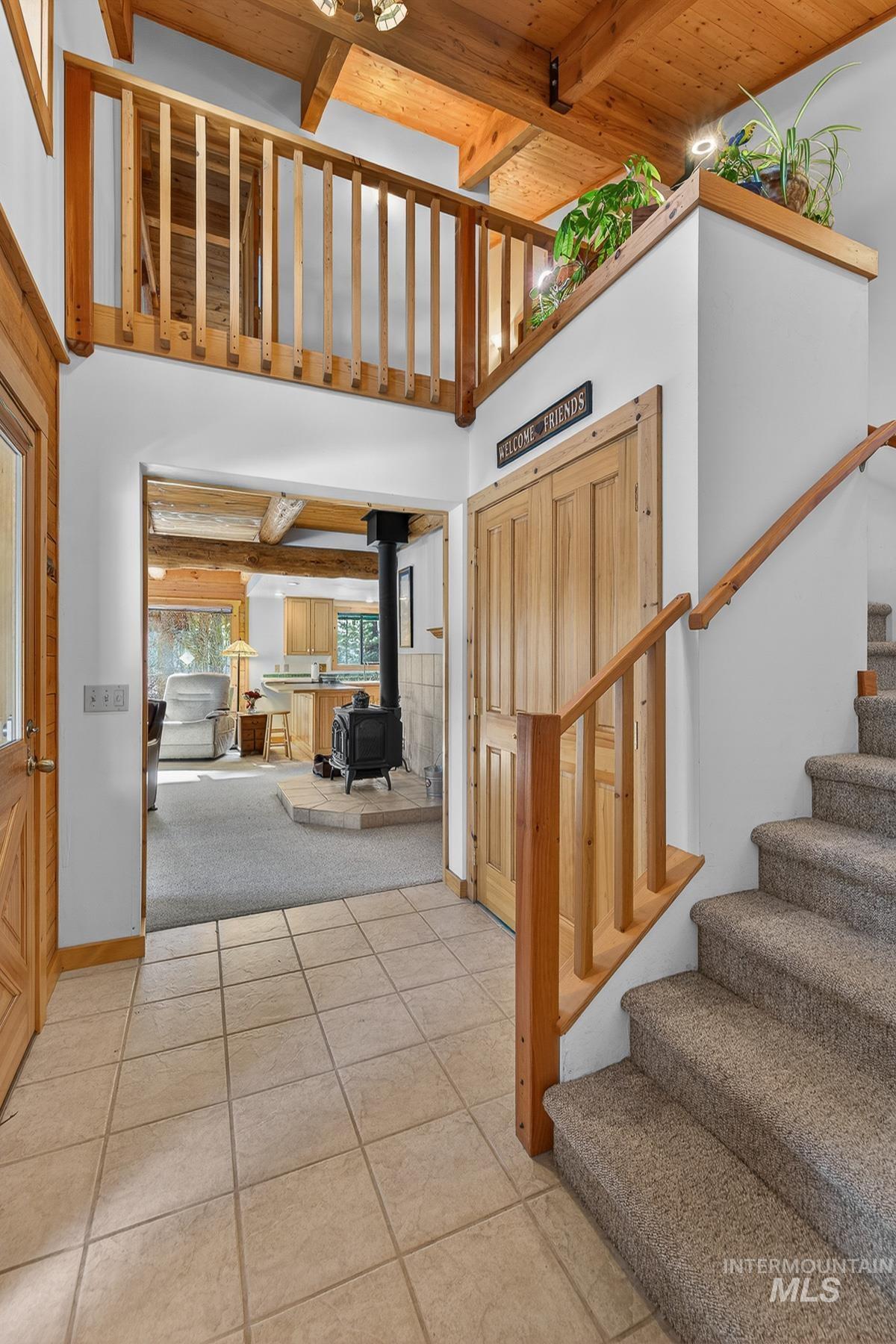 441 Allen Avenue McCall, ID 83638 - Photo 13 of 46 Entrance foyer featuring a wood stove and a high wooden beamed ceiling
