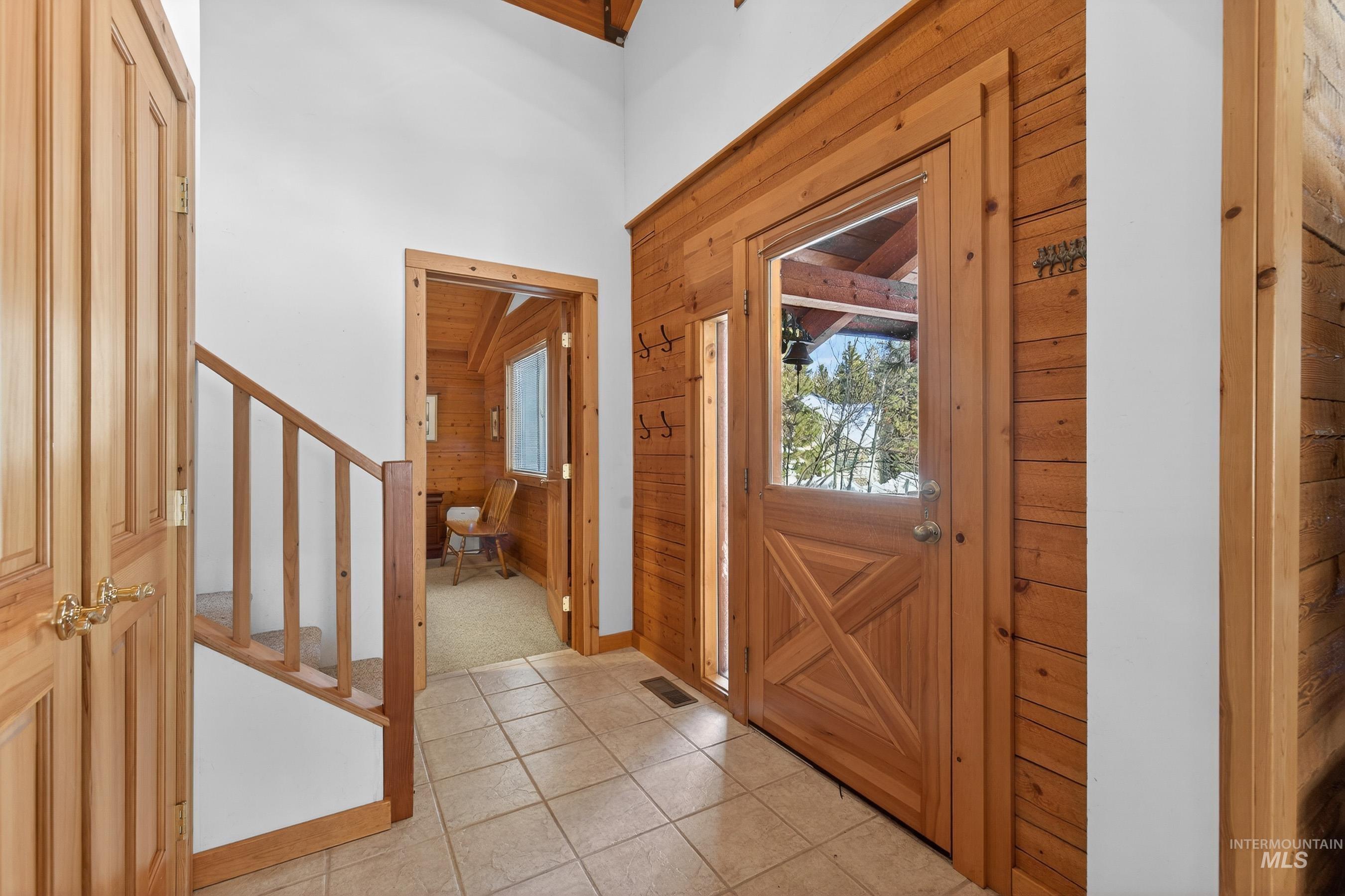 441 Allen Avenue McCall, ID 83638 - Photo 14 of 46 Entryway with wood walls and light tile patterned flooring