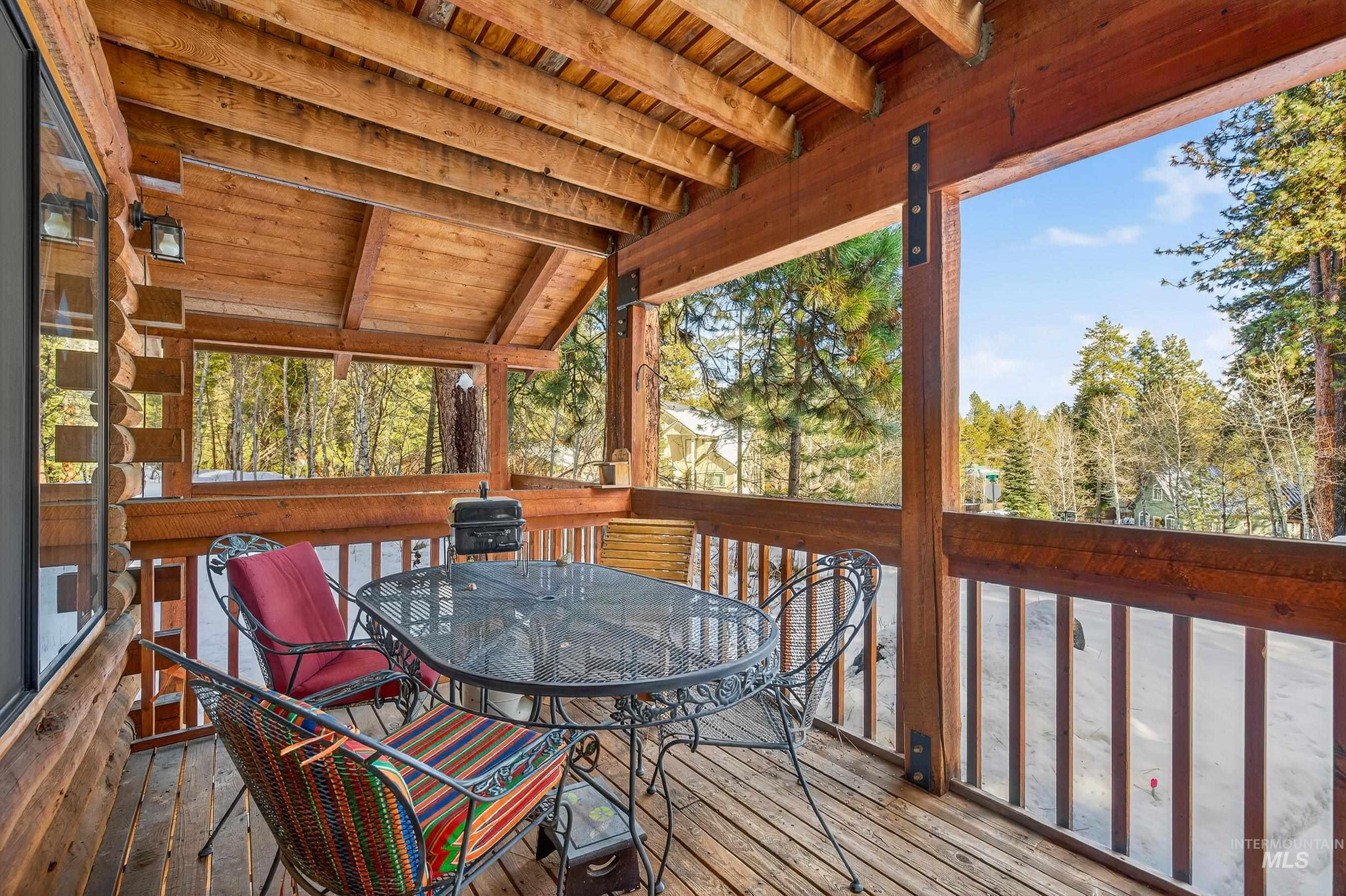 441 Allen Avenue McCall, ID 83638 - Photo 18 of 46 Sunroom featuring outdoor dining space, a wooden deck, and vaulted ceiling with beams