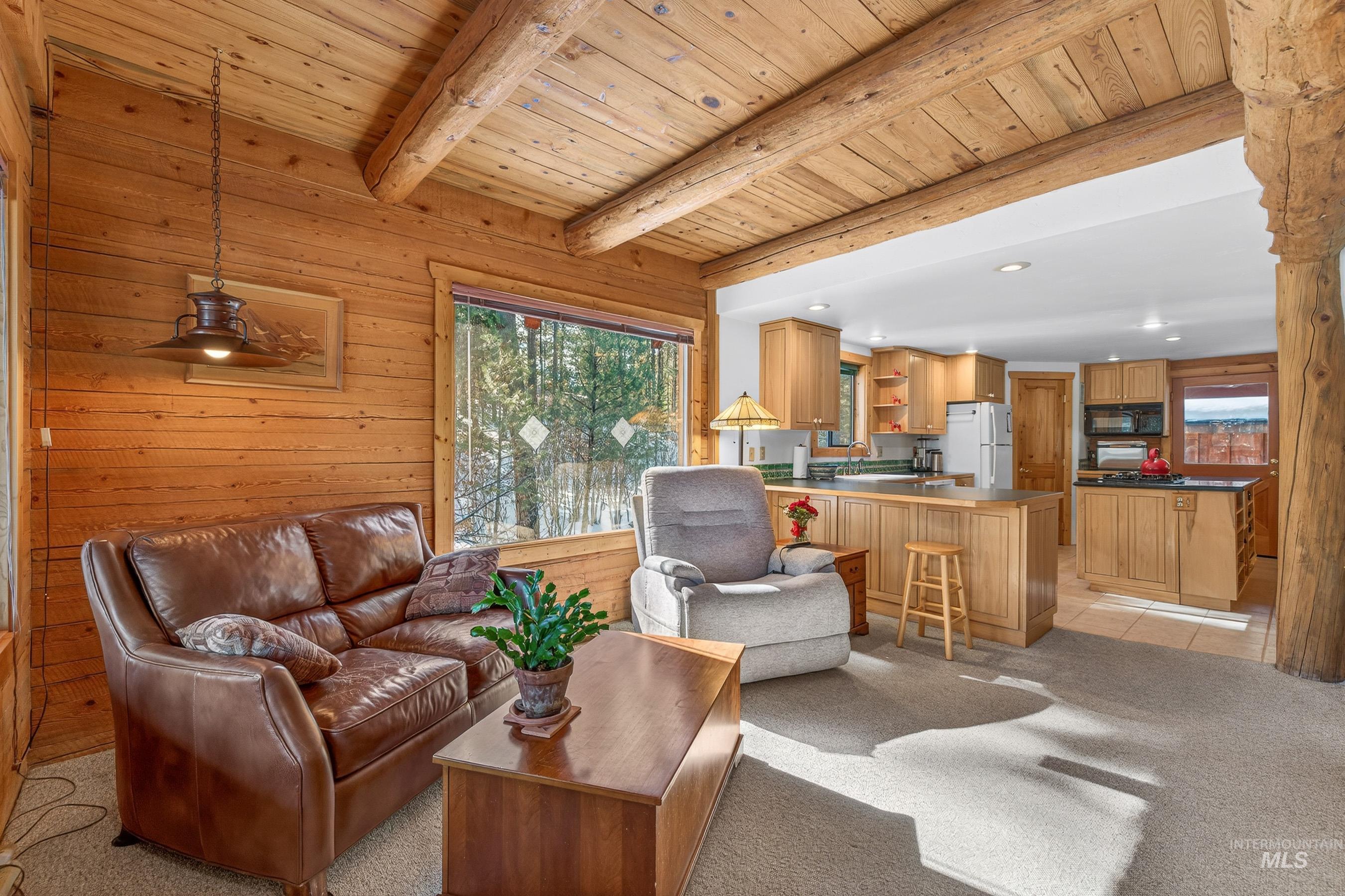 441 Allen Avenue McCall, ID 83638 - Photo 23 of 46 Living area with wood walls, light colored carpet, recessed lighting, and a wooden ceiling with exposed beams