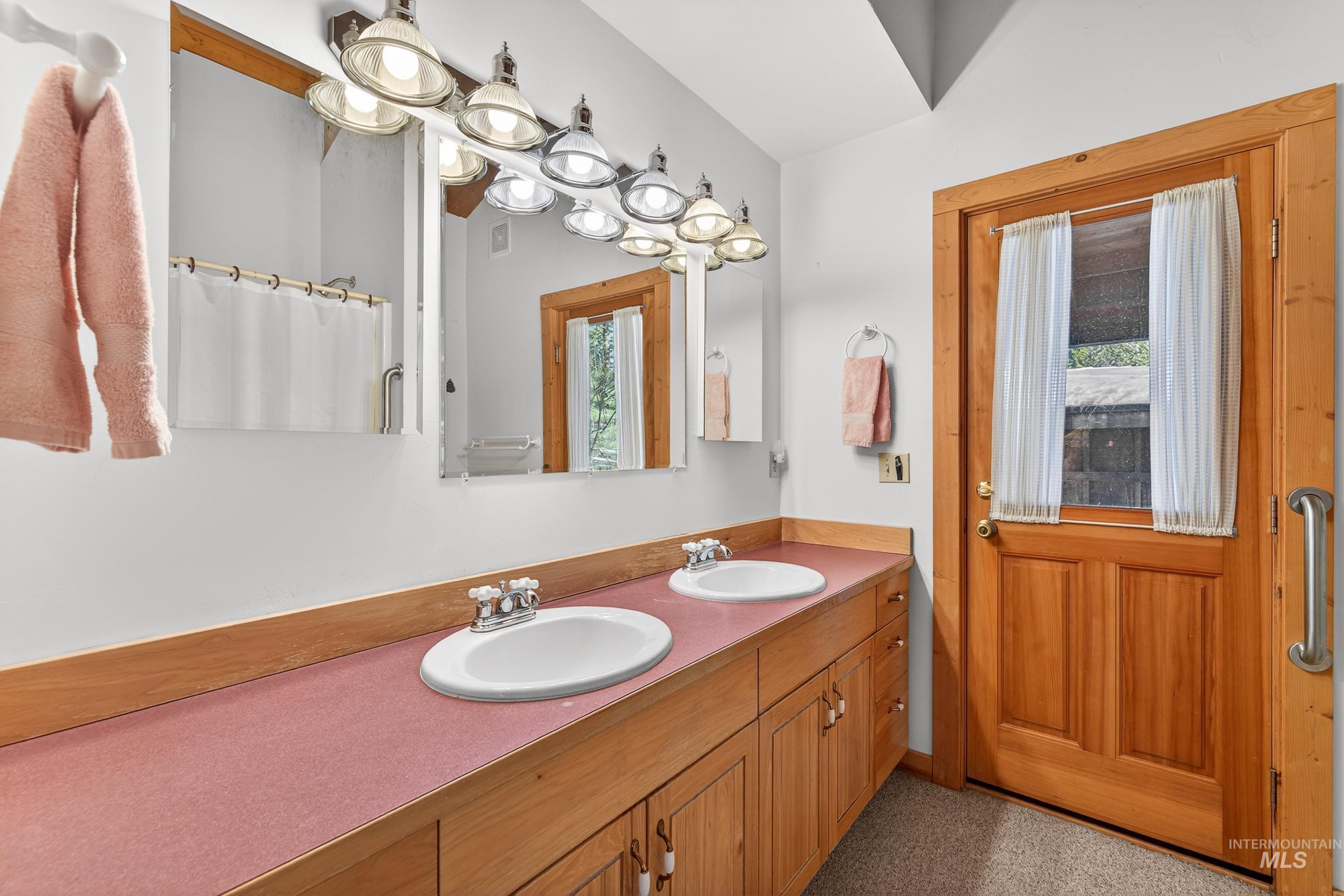 441 Allen Avenue McCall, ID 83638 - Photo 34 of 46 Full bath featuring a shower with shower curtain, double vanity, and healthy amount of natural light