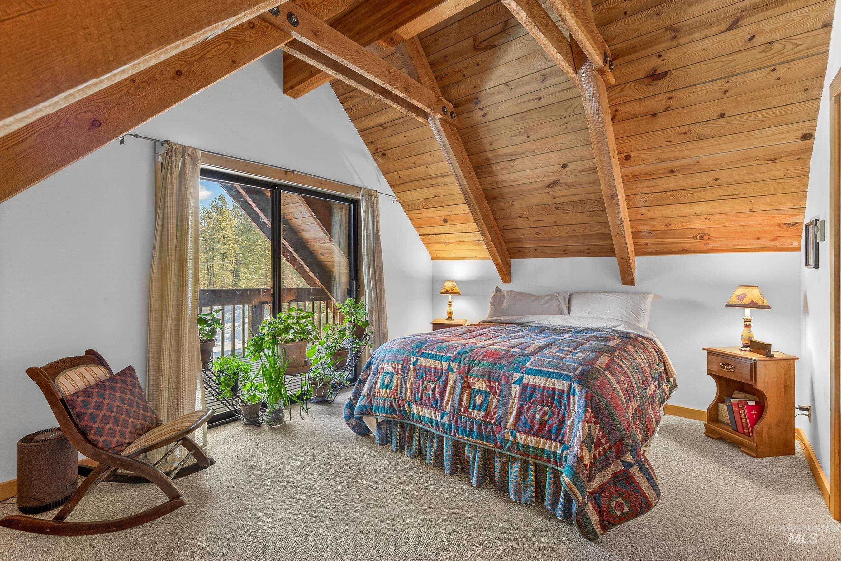 441 Allen Avenue McCall, ID 83638 - Photo 37 of 46 Bedroom with light colored carpet and a wooden ceiling with exposed beams