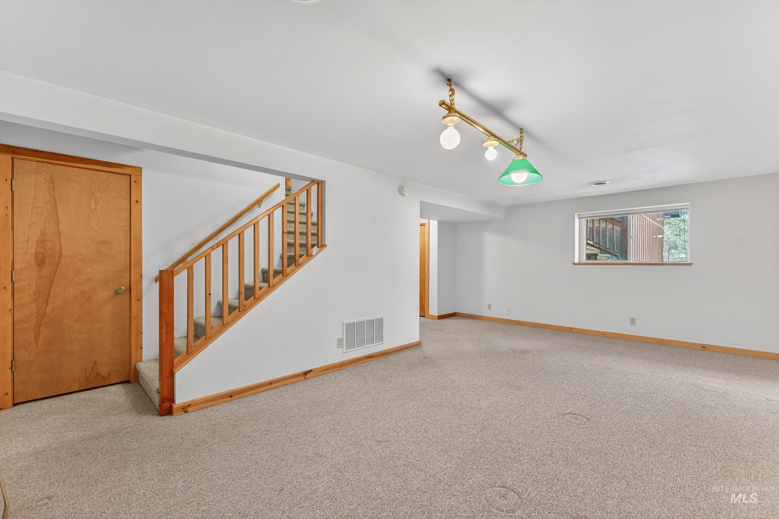 441 Allen Avenue McCall, ID 83638 - Photo 43 of 46 Unfurnished living room featuring stairway and carpet floors