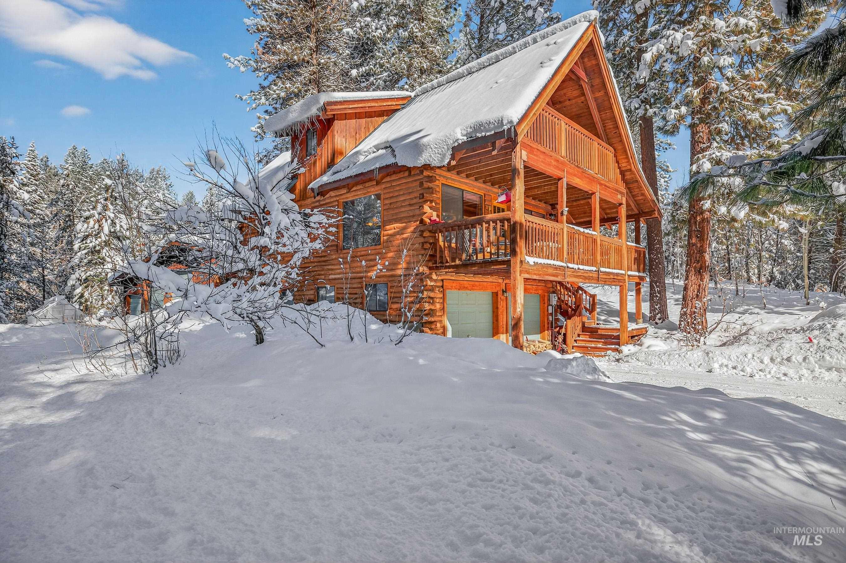 441 Allen Avenue McCall, ID 83638 - Photo 7 of 46 Snow covered house featuring a garage, a deck, and log siding