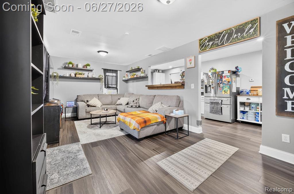 7715 Beech Daly Road Taylor, MI 48180 - Photo 14 of 21 Living area featuring wood-finish flooring, light gray walls, a built-in pass-through to the kitchen, and recessed lighting