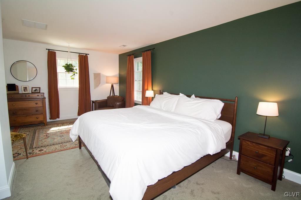 1470 Benner School Road Quakertown, PA 18951 - Photo 19 of 47 a bedroom with a bed mirror and window