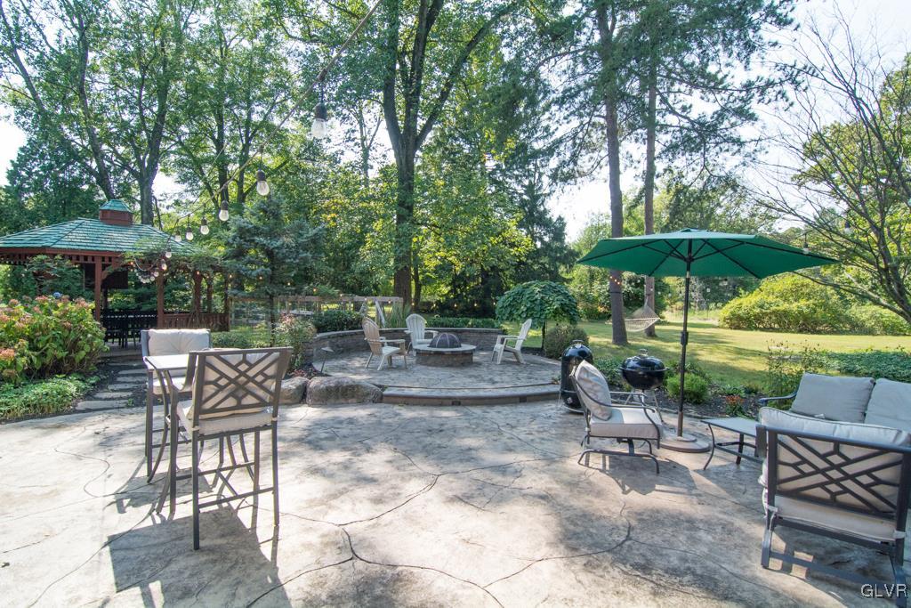 1470 Benner School Road Quakertown, PA 18951 - Photo 35 of 47 a view of patio with chairs and a table under an umbrella
