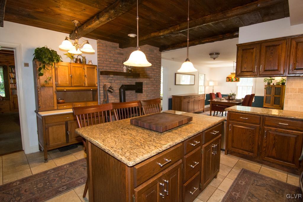 1470 Benner School Road Quakertown, PA 18951 - Photo 5 of 47 a kitchen with stainless steel appliances granite countertop a sink a stove and a wooden cabinets
