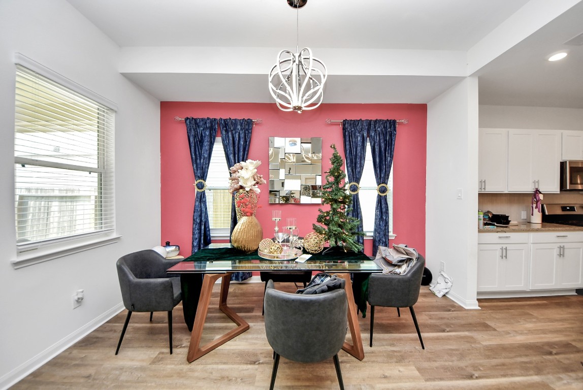 9447 Klein Lane Houston, TX 77044 - Photo 13 of 41 a view of a dining room with furniture window and wooden floor