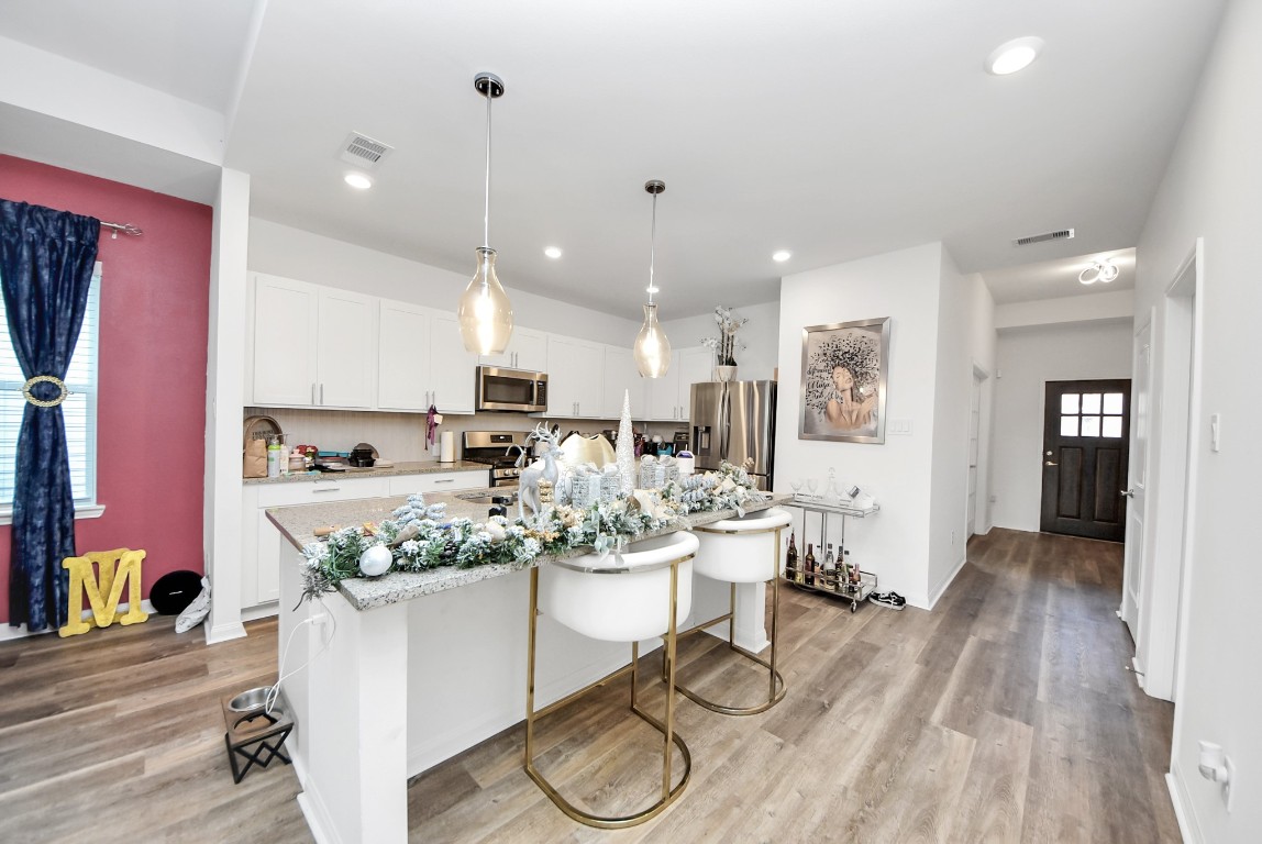 9447 Klein Lane Houston, TX 77044 - Photo 15 of 41 a kitchen with stainless steel appliances granite countertop a stove refrigerator and cabinets