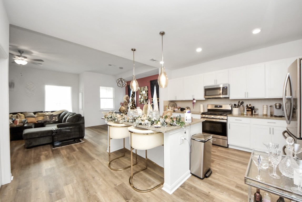 9447 Klein Lane Houston, TX 77044 - Photo 16 of 41 a kitchen with a refrigerator and a stove top oven