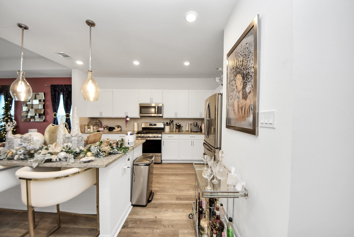 9447 Klein Lane Houston, TX 77044 - Photo 17 of 41 a kitchen with stainless steel appliances kitchen island granite countertop a sink and cabinets