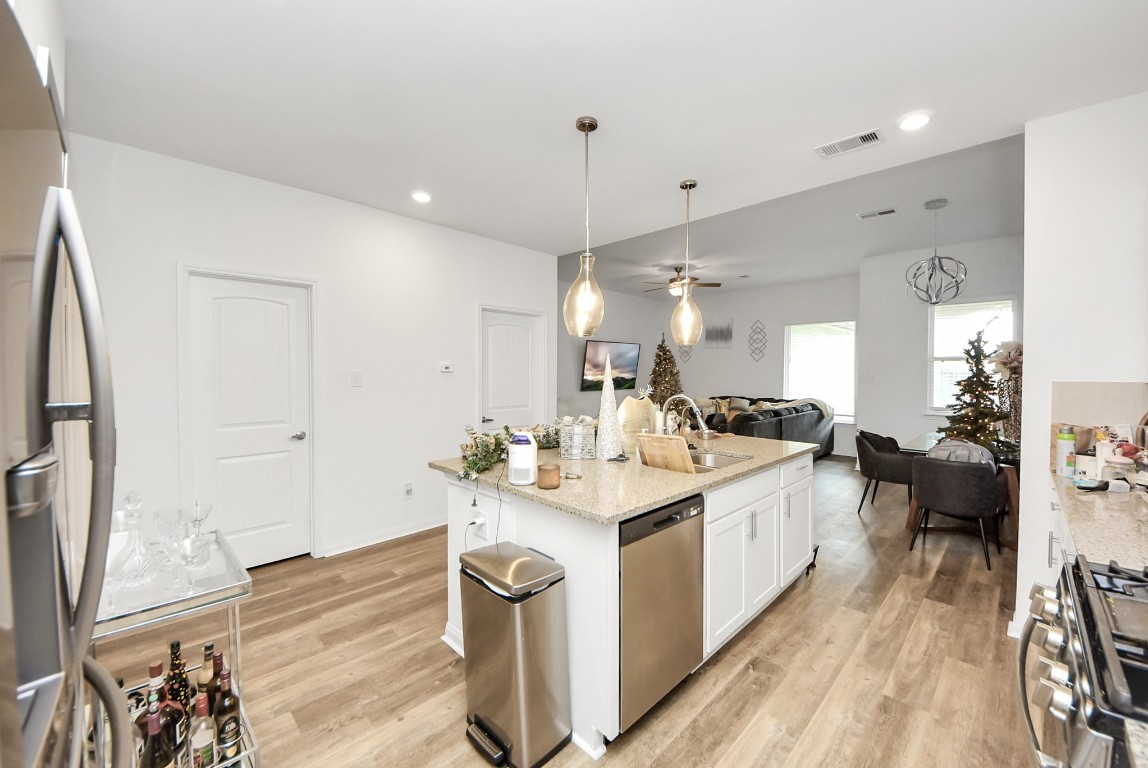9447 Klein Lane Houston, TX 77044 - Photo 18 of 41 a large white kitchen with sink a refrigerator and a stove