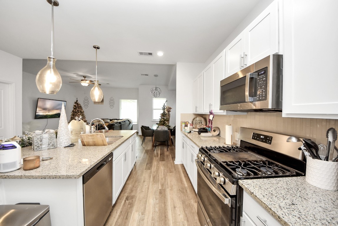 9447 Klein Lane Houston, TX 77044 - Photo 19 of 41 a kitchen with sink stove and cabinets