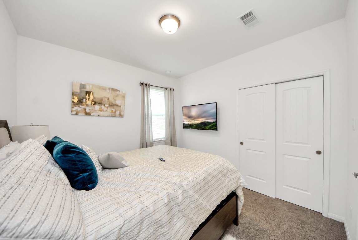 9447 Klein Lane Houston, TX 77044 - Photo 22 of 41 a bedroom with a bed and a painting on the wall