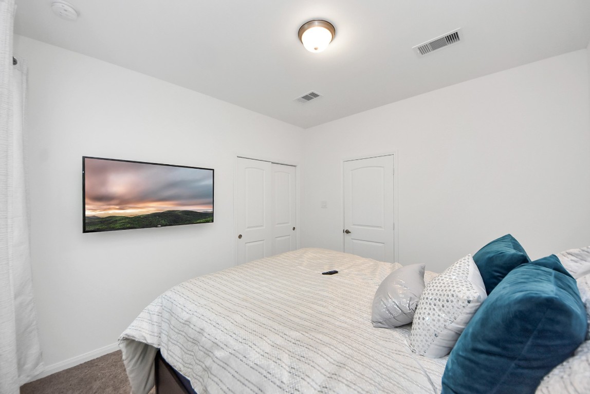 9447 Klein Lane Houston, TX 77044 - Photo 23 of 41 a bedroom with a bed and a wall painting